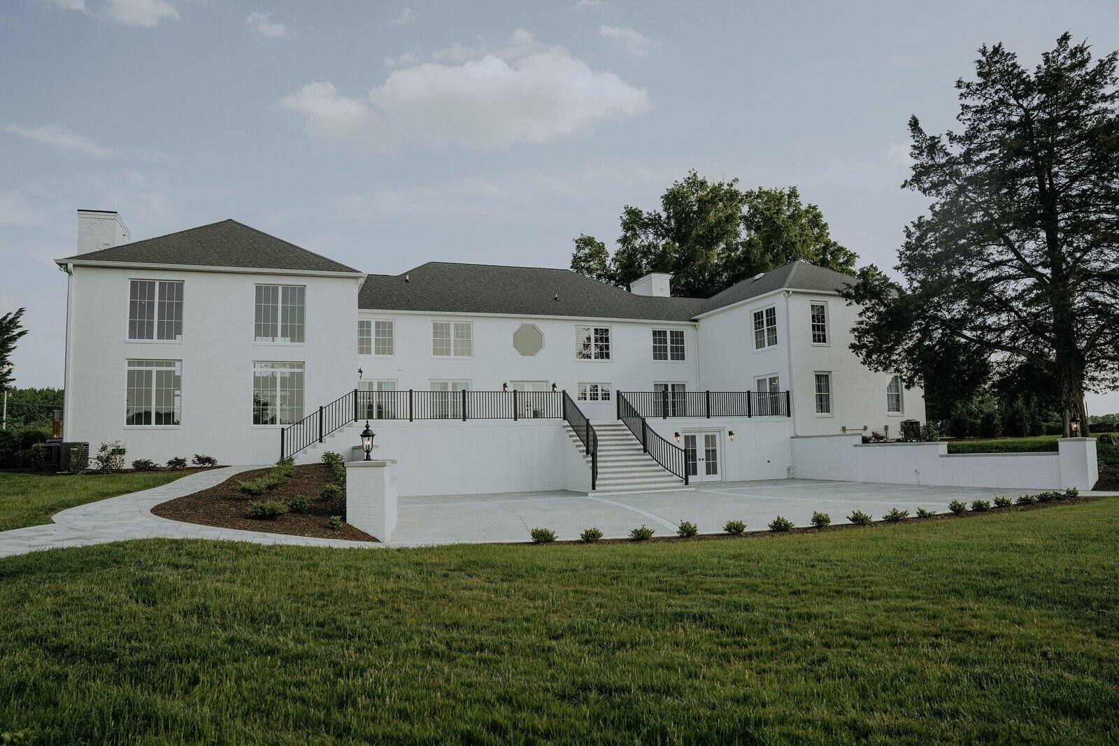 The back of the manor and its terraces across the lawn