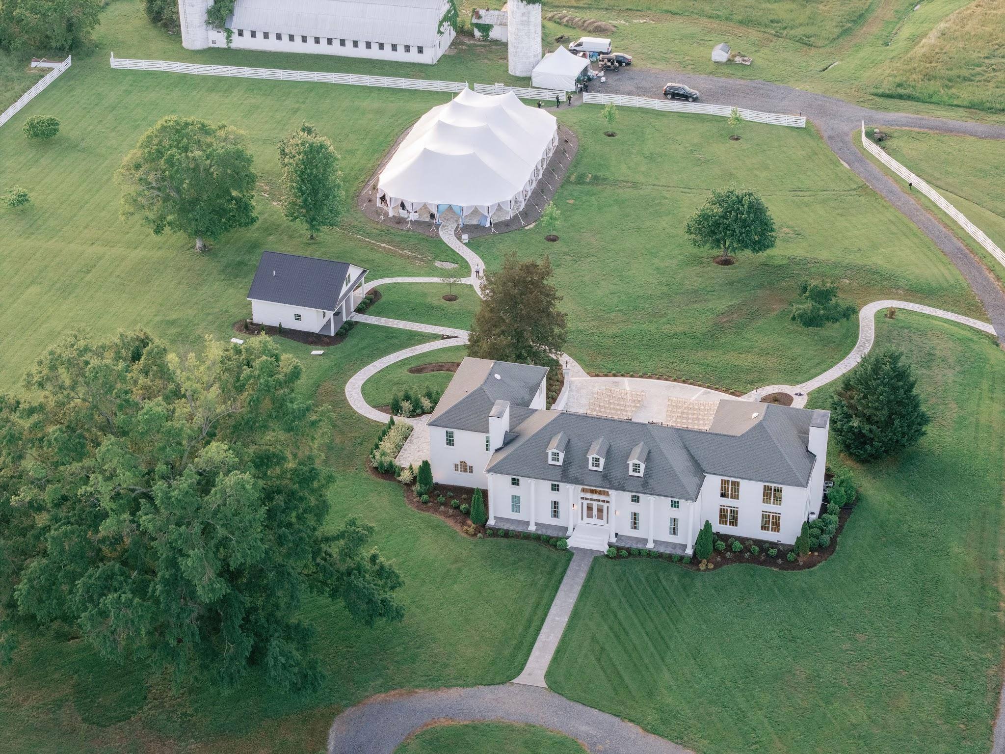 Aerial view of the manor, lawns and sailcloth tent