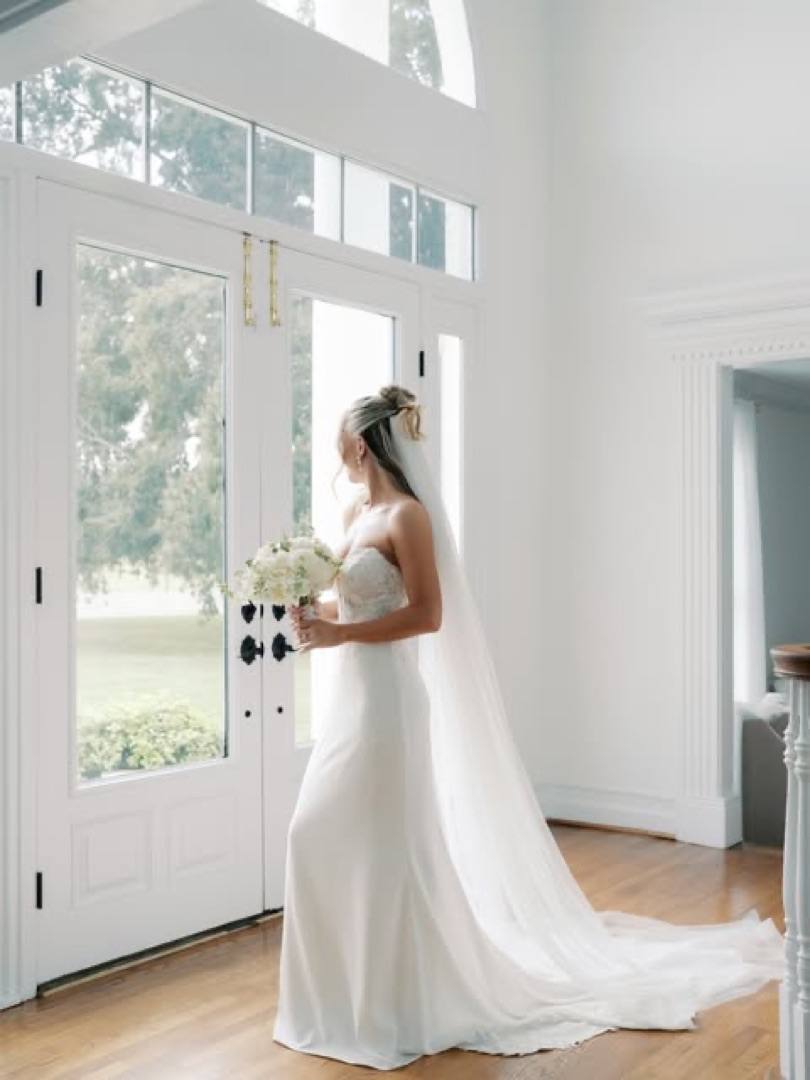 Instagram: a bride by the tall windows of the manor
