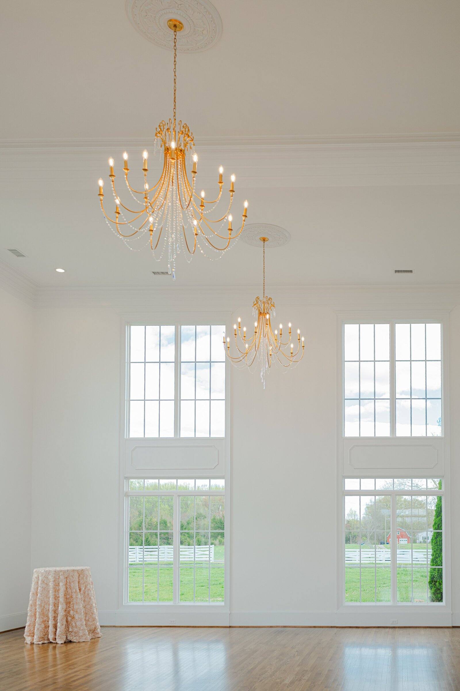 Gold chandeliers and tall windows in the Northfield Estate ballroom